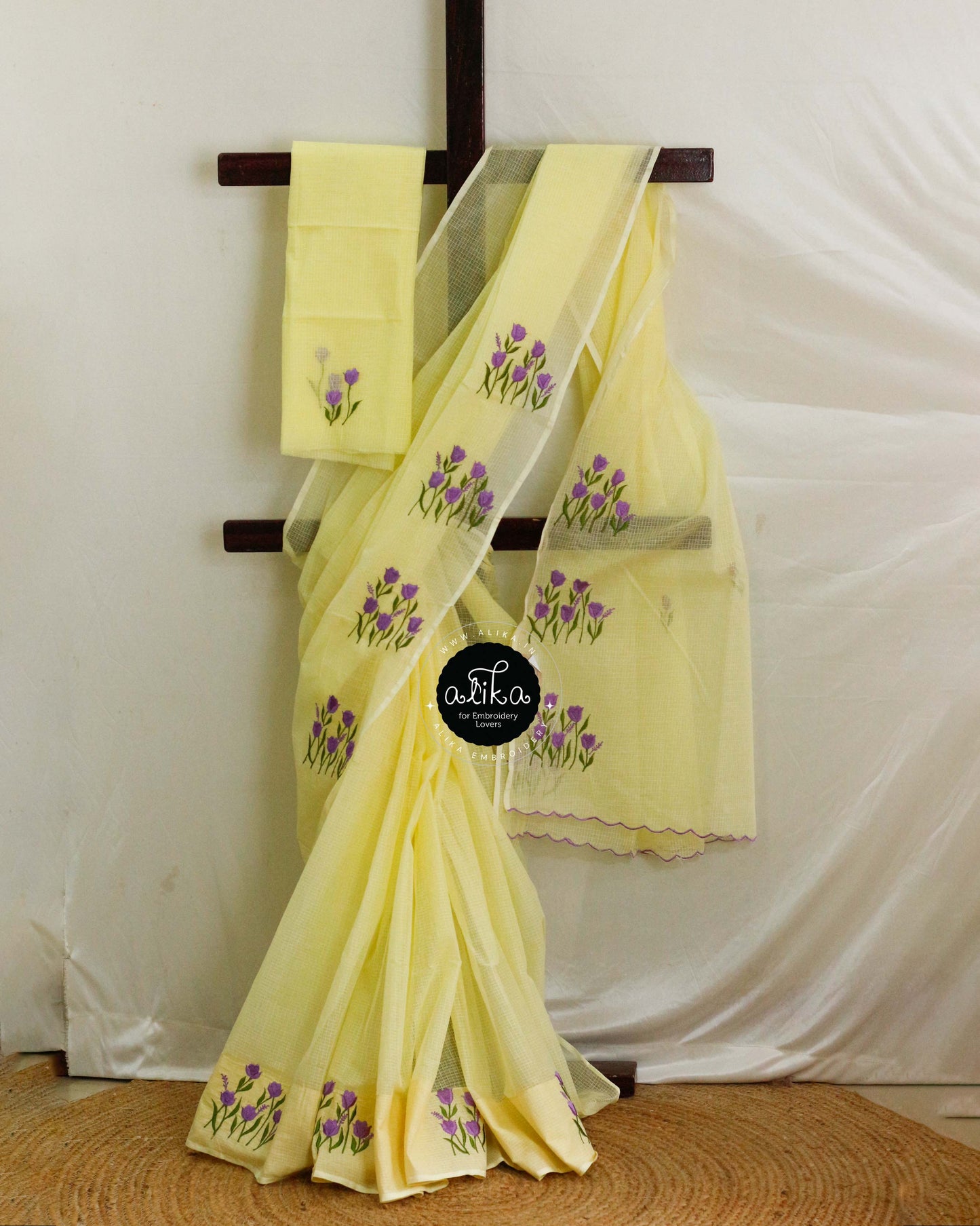 Canary Yellow Kota Saree with Violet Floral Hand Embroidery – Elegant Traditional Wear from Alika Fashion Store